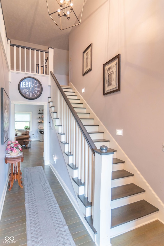 505 Jones Pl, Martinsville, IN 46151 - staircase featuring baseboards, wood finished floors, and a chandelier