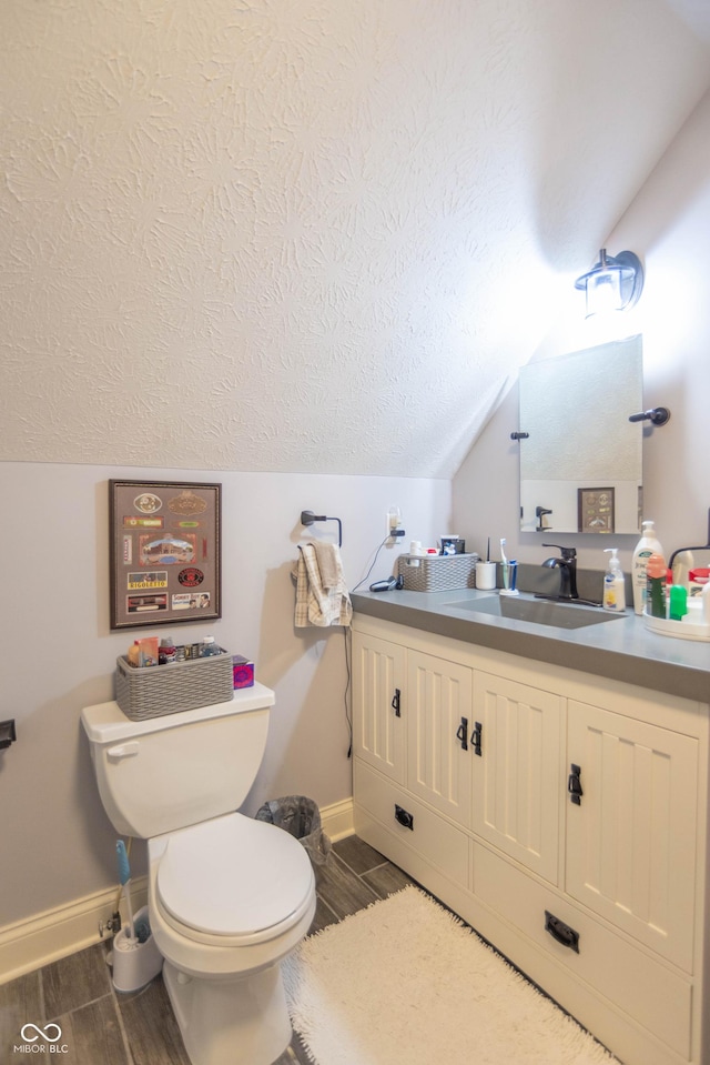 505 Jones Pl, Martinsville, IN 46151 - half bath featuring wood finished floors, toilet, vanity, baseboards, and vaulted ceiling