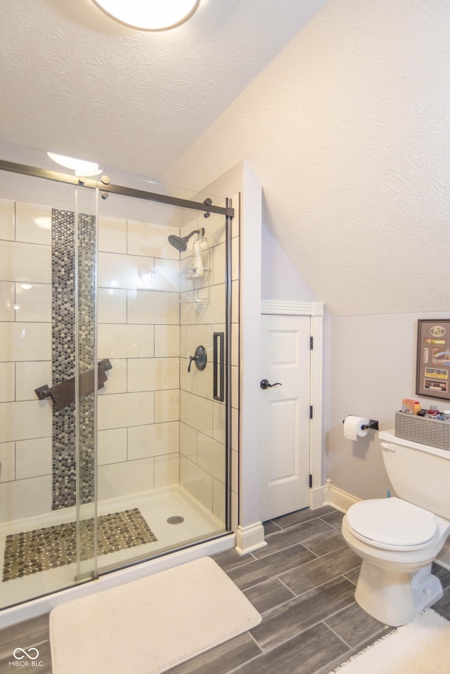 505 Jones Pl, Martinsville, IN 46151 - full bath with a textured ceiling, baseboards, toilet, a shower stall, and wood finish floors