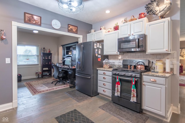 505 Jones Pl, Martinsville, IN 46151 - kitchen featuring stainless steel appliances, baseboards, backsplash, white cabinetry, and wood finished floors