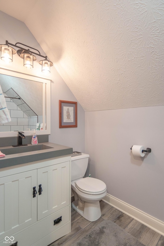 505 Jones Pl, Martinsville, IN 46151 - half bath with lofted ceiling, wood finished floors, toilet, baseboards, and vanity