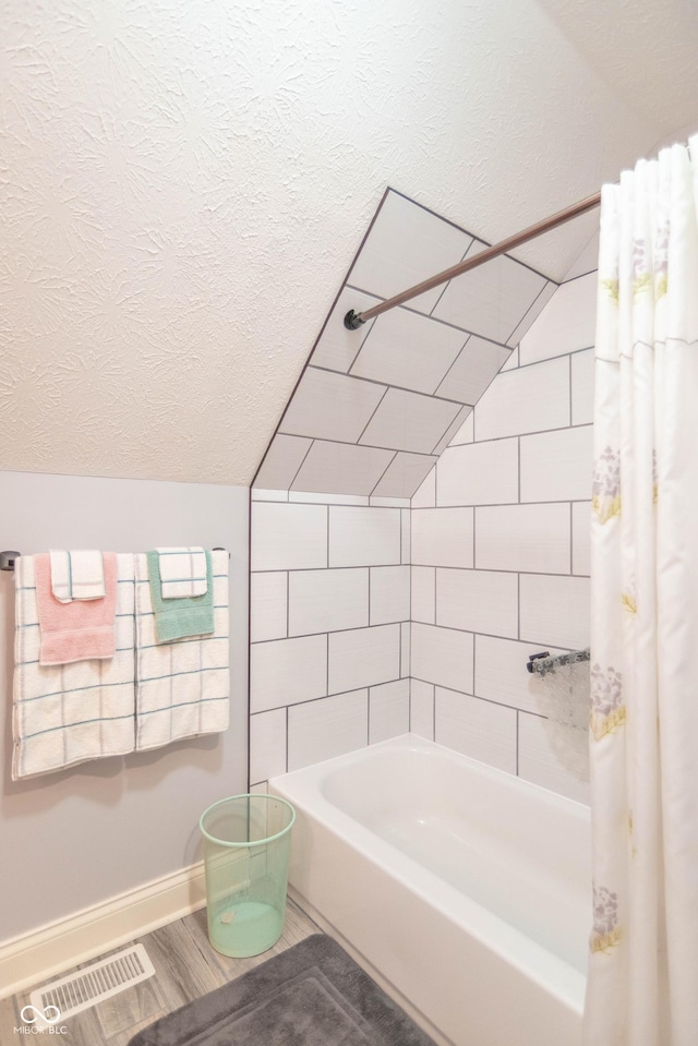 505 Jones Pl, Martinsville, IN 46151 - full bath featuring a textured ceiling, shower / bath combo, baseboards, and wood finished floors