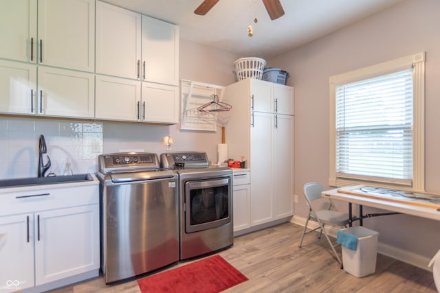 505 Jones Pl, Martinsville, IN 46151 - laundry room with cabinet space, washing machine and clothes dryer, light wood-style floors, ceiling fan, and baseboards