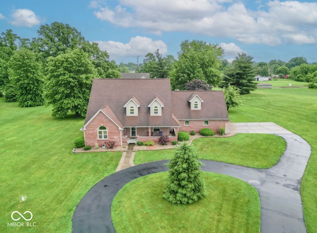505 Jones Pl, Martinsville, IN 46151 - cape cod house featuring brick siding, curved driveway, and a front yard