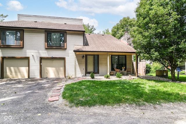 2433 Hideaway S Dr, Indianapolis, IN 46268 - view of front of property with a garage, roof with shingles, a front yard, asphalt driveway, and a chimney