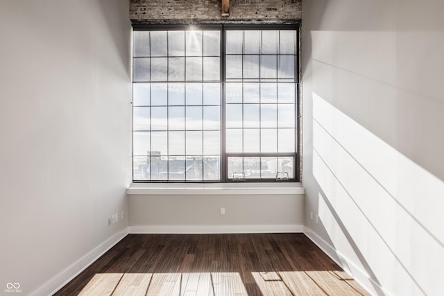 630 N College Ave Unit 409, Indianapolis, IN 46204 - spare room featuring wood finished floors and baseboards