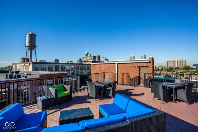 630 N College Ave Unit 409, Indianapolis, IN 46204 - wooden deck featuring outdoor dining space, an outdoor living space, and a view of city