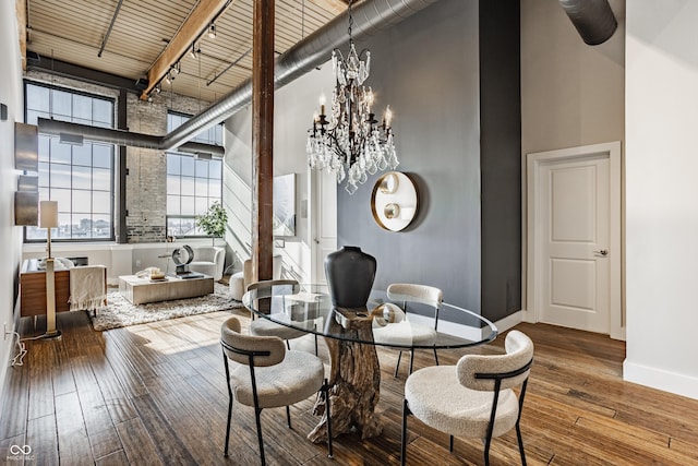 630 N College Ave Unit 409, Indianapolis, IN 46204 - dining space featuring a towering ceiling, baseboards, hardwood / wood-style flooring, wood ceiling, and a chandelier