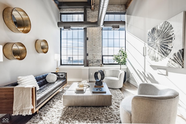 630 N College Ave Unit 409, Indianapolis, IN 46204 - living room featuring wood finished floors and a towering ceiling