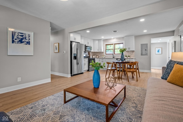 2537 N Boehning St, Indianapolis, IN 46219 - living area featuring electric panel, light wood-style flooring, baseboards, and recessed lighting