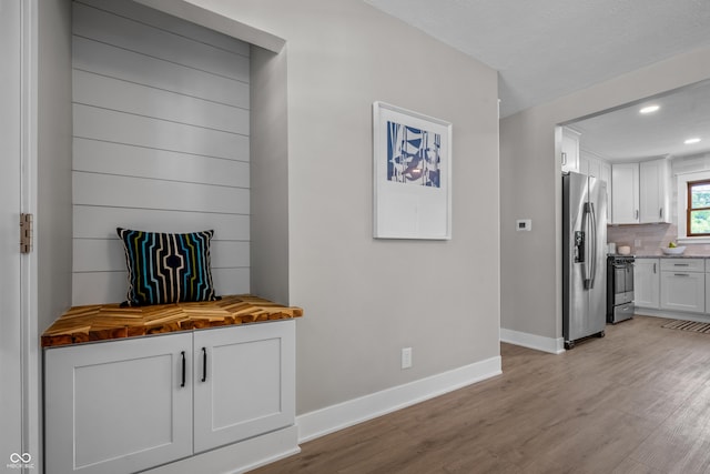 2537 N Boehning St, Indianapolis, IN 46219 - kitchen with appliances with stainless steel finishes, butcher block counters, light wood-style flooring, white cabinets, and recessed lighting
