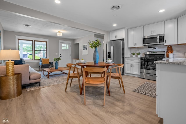 2537 N Boehning St, Indianapolis, IN 46219 - dining space with light wood finished floors and recessed lighting
