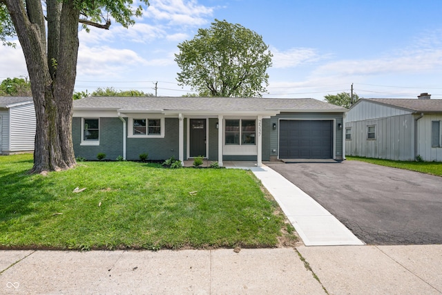 2537 N Boehning St, Indianapolis, IN 46219 - single story home featuring driveway, an attached garage, and a front yard