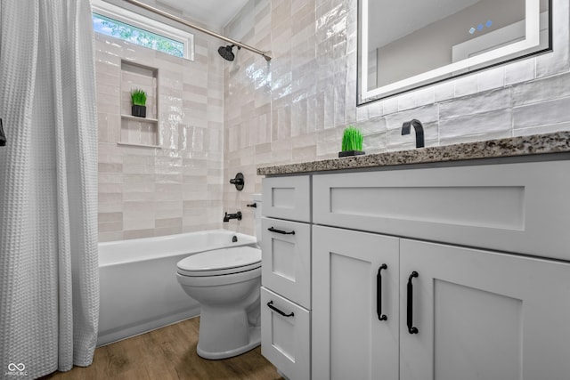 2537 N Boehning St, Indianapolis, IN 46219 - full bathroom featuring vanity, shower / bath combination with curtain, toilet, tile walls, and wood finished floors