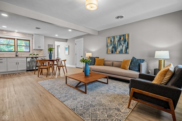 2537 N Boehning St, Indianapolis, IN 46219 - living area featuring light wood-style flooring, beamed ceiling, recessed lighting, and baseboards