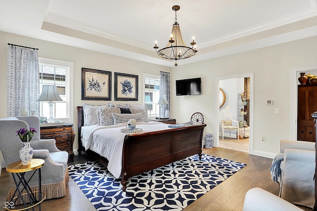 1135 Maclaren Ct, Franklin, IN 46131 - bedroom featuring a chandelier, wood-type flooring, multiple windows, ornamental molding, and a raised ceiling