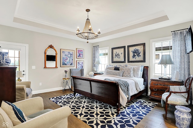1135 Maclaren Ct, Franklin, IN 46131 - bedroom with a tray ceiling, a chandelier, wood finished floors, and ornamental molding
