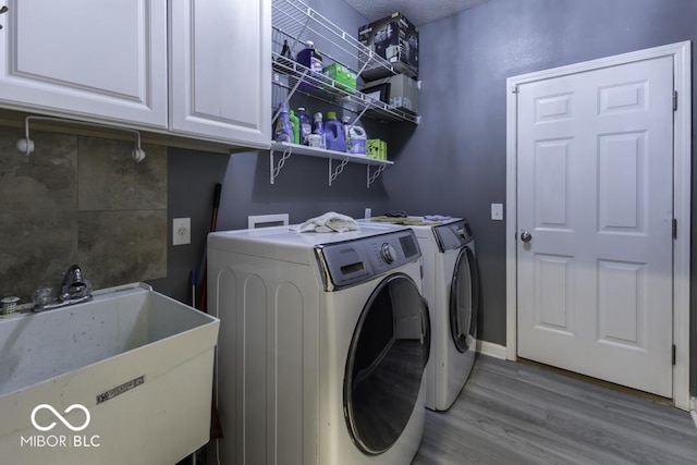 2502 Colinbrook Pkwy, Greenwood, IN 46143 - laundry area with wood finished floors, independent washer and dryer, cabinet space, and baseboards