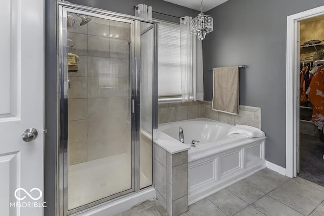 2502 Colinbrook Pkwy, Greenwood, IN 46143 - full bathroom with a garden tub, a spacious closet, a stall shower, tile patterned floors, and a chandelier