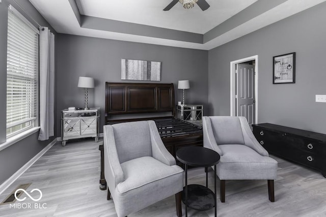 2502 Colinbrook Pkwy, Greenwood, IN 46143 - bedroom with a tray ceiling, light wood-style floors, baseboards, and ceiling fan