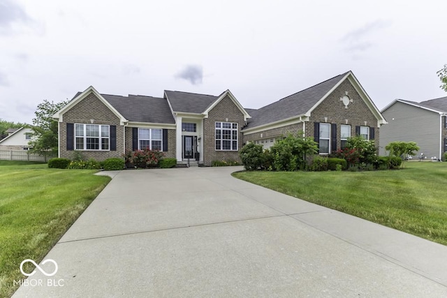 2502 Colinbrook Pkwy, Greenwood, IN 46143 - view of front of house with brick siding, an attached garage, and driveway