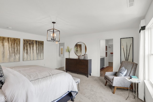 942 Shadow Dr, Danville, IN 46122 - bedroom featuring light colored carpet, a chandelier, and ensuite bathroom