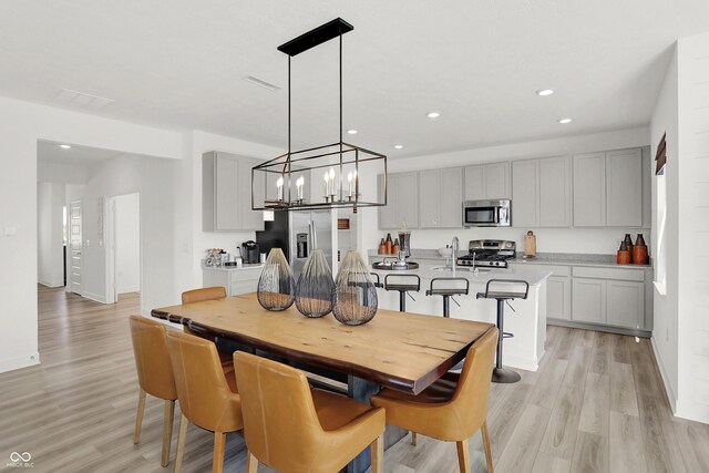 942 Shadow Dr, Danville, IN 46122 - dining room with light wood finished floors, recessed lighting, a chandelier, and baseboards