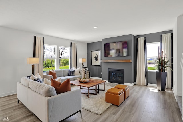 942 Shadow Dr, Danville, IN 46122 - living area featuring a glass covered fireplace, light wood-type flooring, baseboards, and recessed lighting