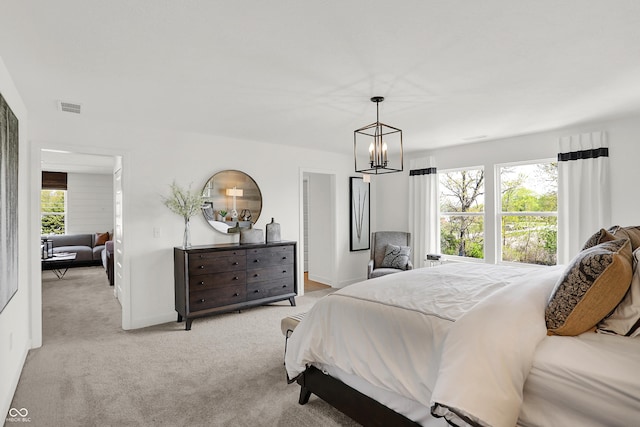 942 Shadow Dr, Danville, IN 46122 - bedroom featuring light carpet, a chandelier, and baseboards