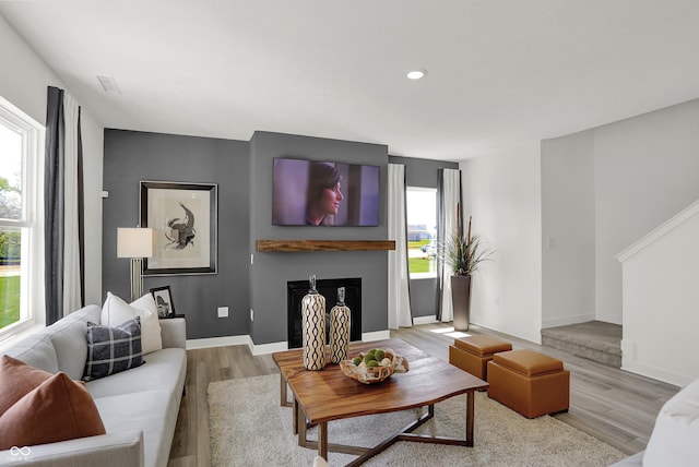 942 Shadow Dr, Danville, IN 46122 - living room featuring plenty of natural light, wood finished floors, a fireplace, and recessed lighting