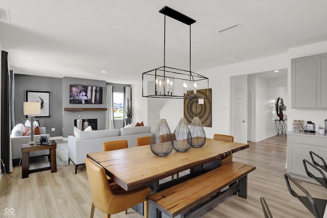 942 Shadow Dr, Danville, IN 46122 - dining area with a chandelier, light wood-type flooring, and baseboards