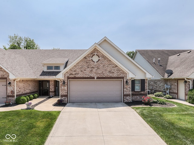 5351 Abbington Ave, Plainfield, IN 46168 - view of front of house with brick siding, an attached garage, concrete driveway, and a front lawn