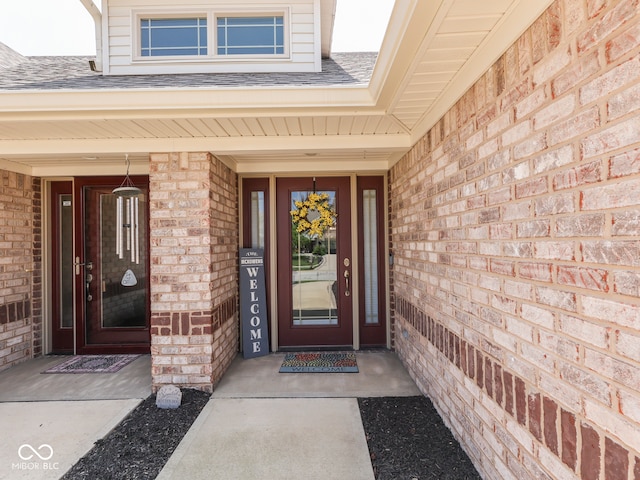 5351 Abbington Ave, Plainfield, IN 46168 - doorway to property featuring brick siding, a shingled roof, and covered porch