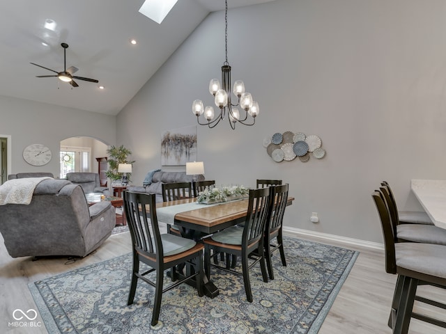 5351 Abbington Ave, Plainfield, IN 46168 - dining area with arched walkways, high vaulted ceiling, light wood-type flooring, a ceiling fan, and a skylight