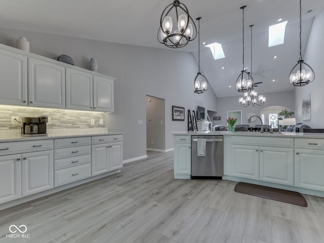 5351 Abbington Ave, Plainfield, IN 46168 - kitchen with dishwasher, a chandelier, a skylight, decorative light fixtures, and tasteful backsplash