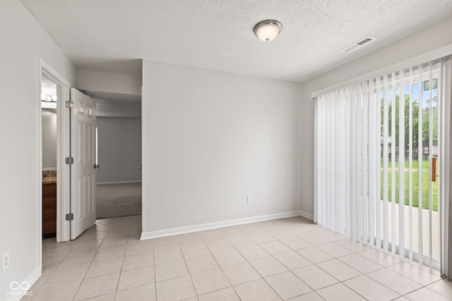 1903 Windy Hill Ln, Indianapolis, IN 46239 - unfurnished room with a textured ceiling and light tile patterned flooring
