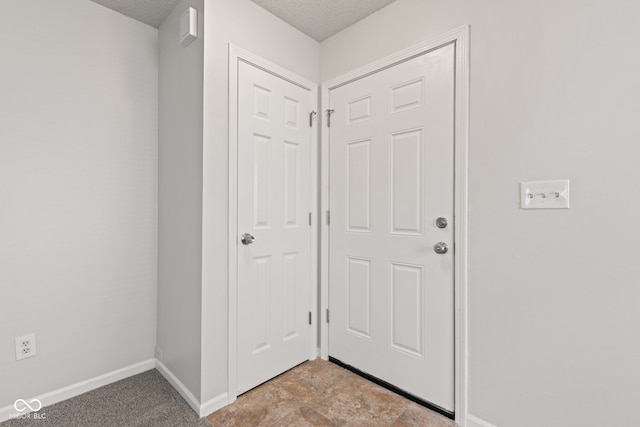 1903 Windy Hill Ln, Indianapolis, IN 46239 - entryway featuring baseboards and a textured ceiling