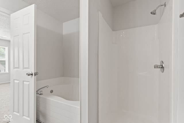 1903 Windy Hill Ln, Indianapolis, IN 46239 - bathroom featuring a textured ceiling, a garden tub, and tiled shower