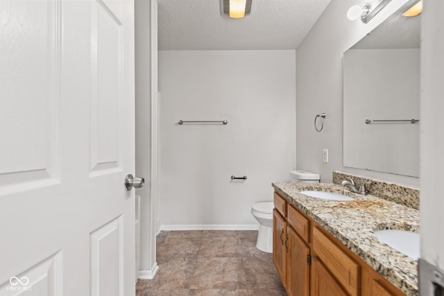 1903 Windy Hill Ln, Indianapolis, IN 46239 - bathroom with double vanity, a textured ceiling, and stone finish floors