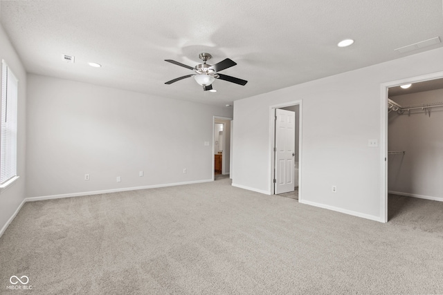 1903 Windy Hill Ln, Indianapolis, IN 46239 - unfurnished bedroom with a spacious closet, carpet flooring, multiple windows, a ceiling fan, and recessed lighting