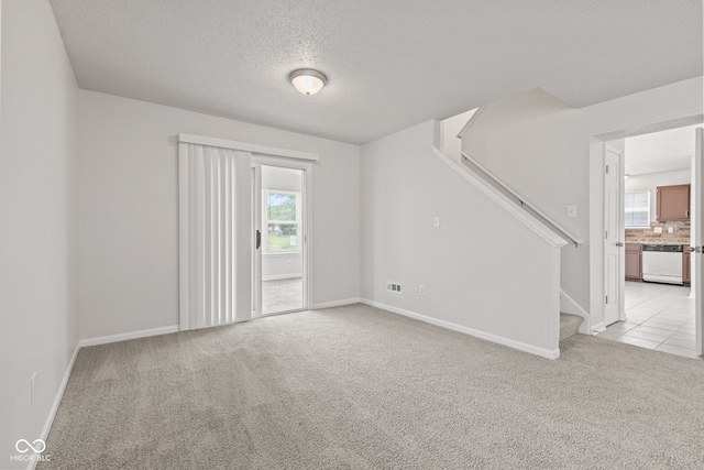 1903 Windy Hill Ln, Indianapolis, IN 46239 - unfurnished room featuring light carpet, stairs, and a textured ceiling