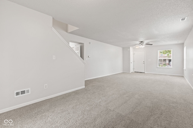 1903 Windy Hill Ln, Indianapolis, IN 46239 - carpeted empty room featuring a textured ceiling, a ceiling fan, and stairs