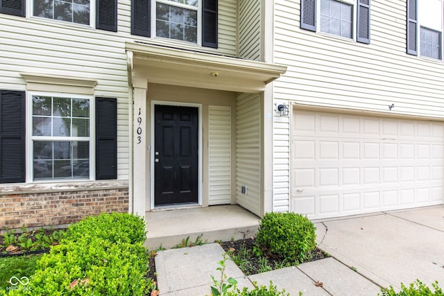 1903 Windy Hill Ln, Indianapolis, IN 46239 - entrance to property with brick siding, concrete driveway, and a garage