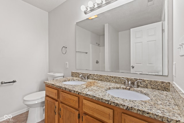1903 Windy Hill Ln, Indianapolis, IN 46239 - bathroom featuring double vanity, a shower, and a textured ceiling