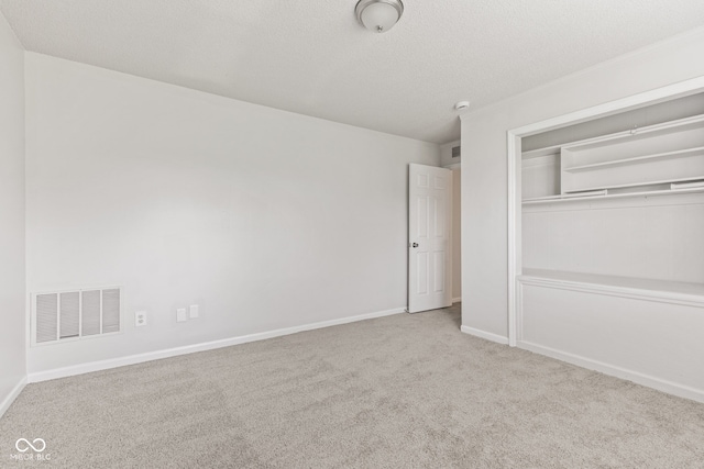 1903 Windy Hill Ln, Indianapolis, IN 46239 - unfurnished bedroom with carpet flooring, a closet, and a textured ceiling
