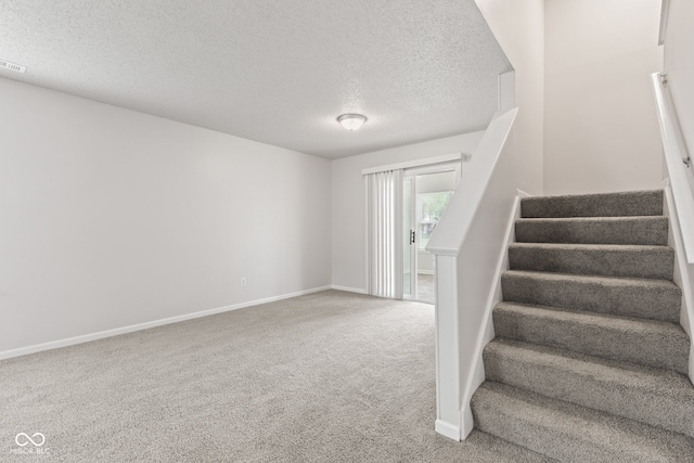 1903 Windy Hill Ln, Indianapolis, IN 46239 - stairway with a textured ceiling and carpet floors