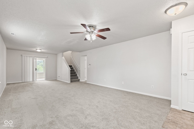 1903 Windy Hill Ln, Indianapolis, IN 46239 - unfurnished living room featuring light carpet, ceiling fan, a textured ceiling, and stairs