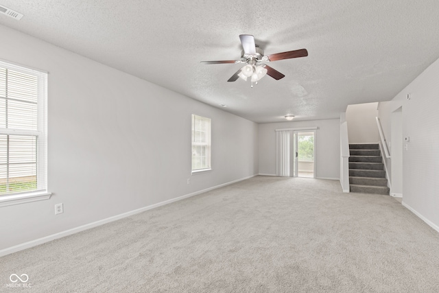 1903 Windy Hill Ln, Indianapolis, IN 46239 - spare room featuring a textured ceiling, ceiling fan, stairs, and carpet