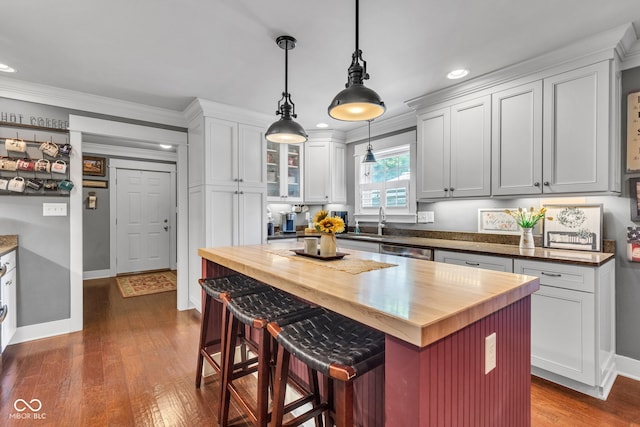 900 W Busby St, Lebanon, IN 46052 - kitchen featuring wooden counters, recessed lighting, ornamental molding, a kitchen breakfast bar, and dark wood-type flooring
