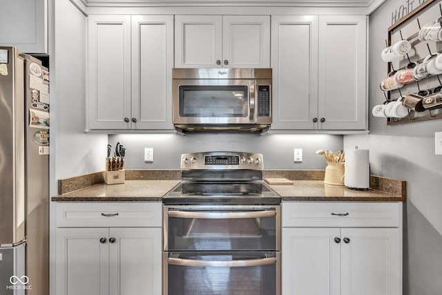 900 W Busby St, Lebanon, IN 46052 - kitchen featuring stainless steel appliances, white cabinets, and dark stone counters